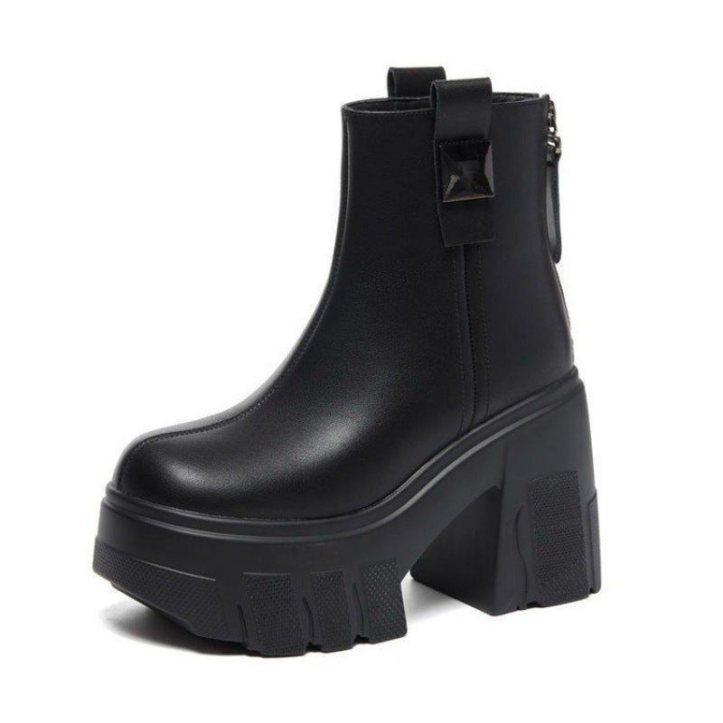 Black platform ankle boot with chunky lug sole, block heel and back tab on a white background