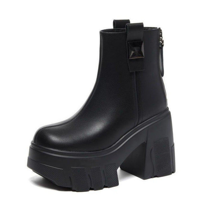 Black platform ankle boot with chunky lug sole, block heel and back tab on a white background