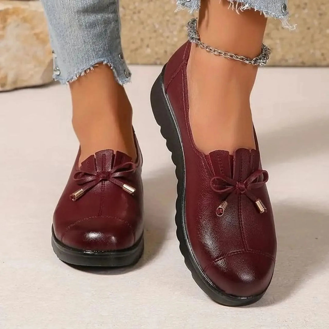 Burgundy platform loafers with bow detail worn with frayed hem jeans