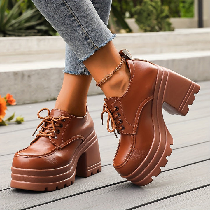 Side view of brown chunky platform Oxford shoes with lug sole and block heel