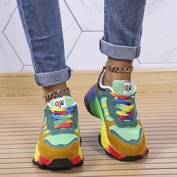 Front view of green multi platform sneakers with rainbow laces