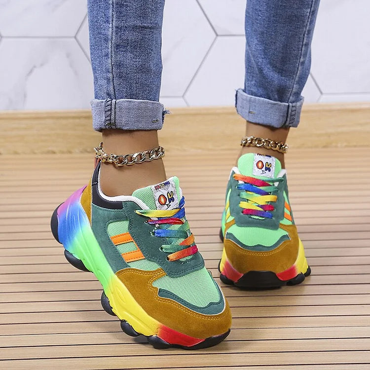 Green multi lace up sneakers angled with rainbow sole and gold chain