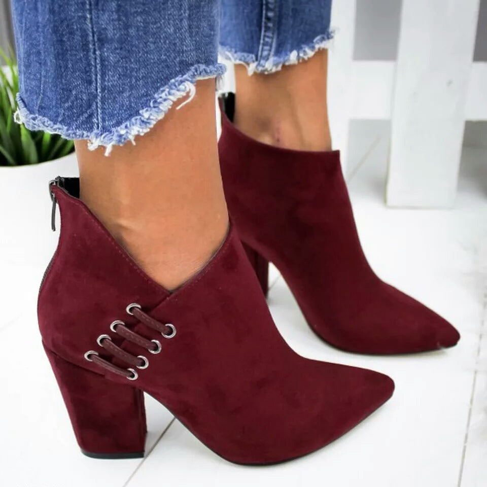 Burgundy pointed toe booties worn with frayed cropped denim