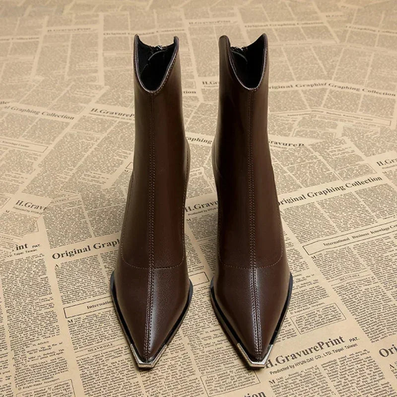 Front view of brown pointed toe ankle boots with metal toe tip