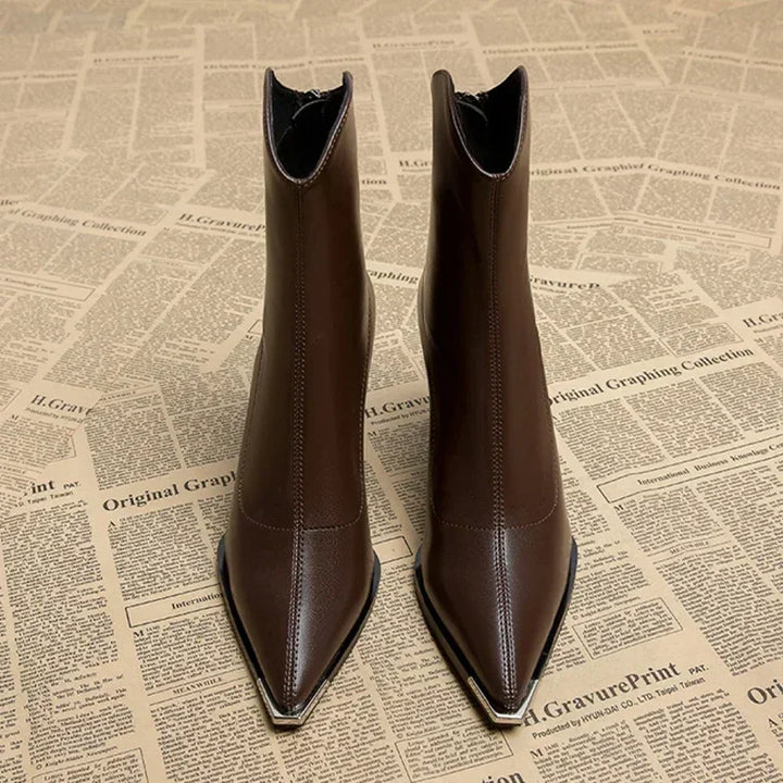 Front view of brown pointed toe ankle boots with metal toe tip