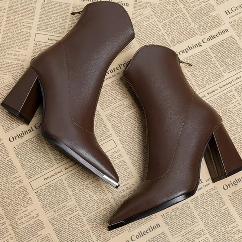Brown pointed toe block heel ankle boots seen from the side and back