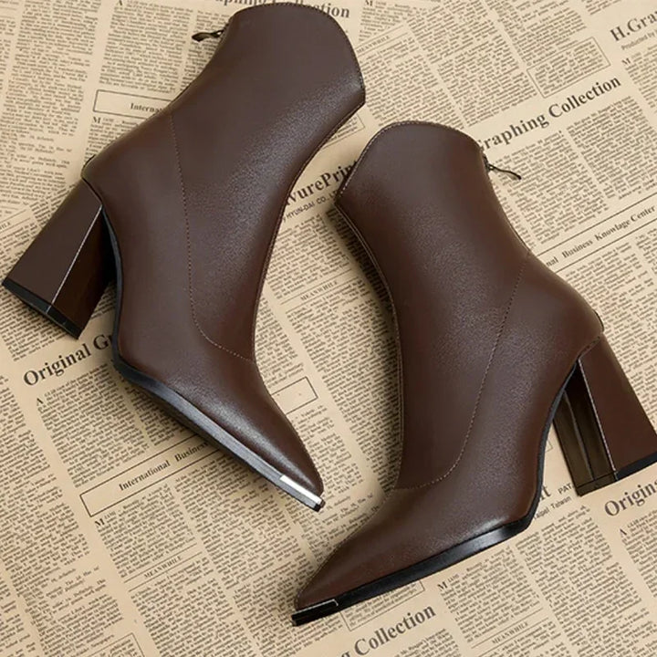 Brown pointed toe block heel ankle boots seen from the side and back