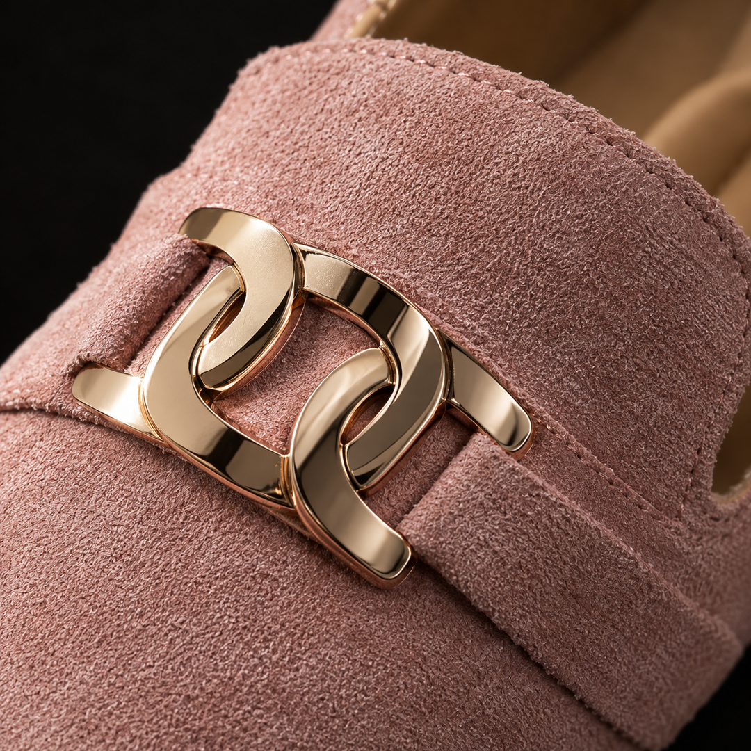 Close-up of the gold chain ornament on the pink suede look loafer