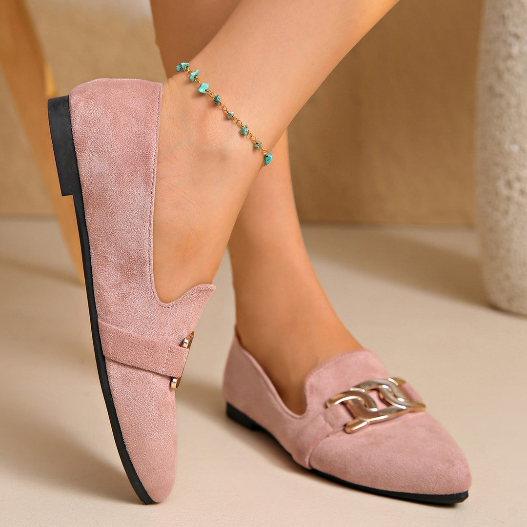 Side view of a dusty pink flat worn with a beaded anklet