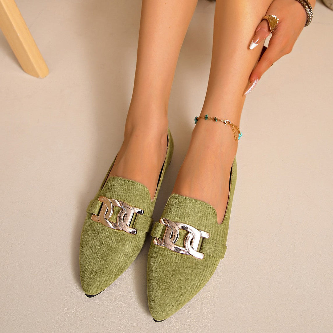 Olive green pointed toe flats worn together, front view