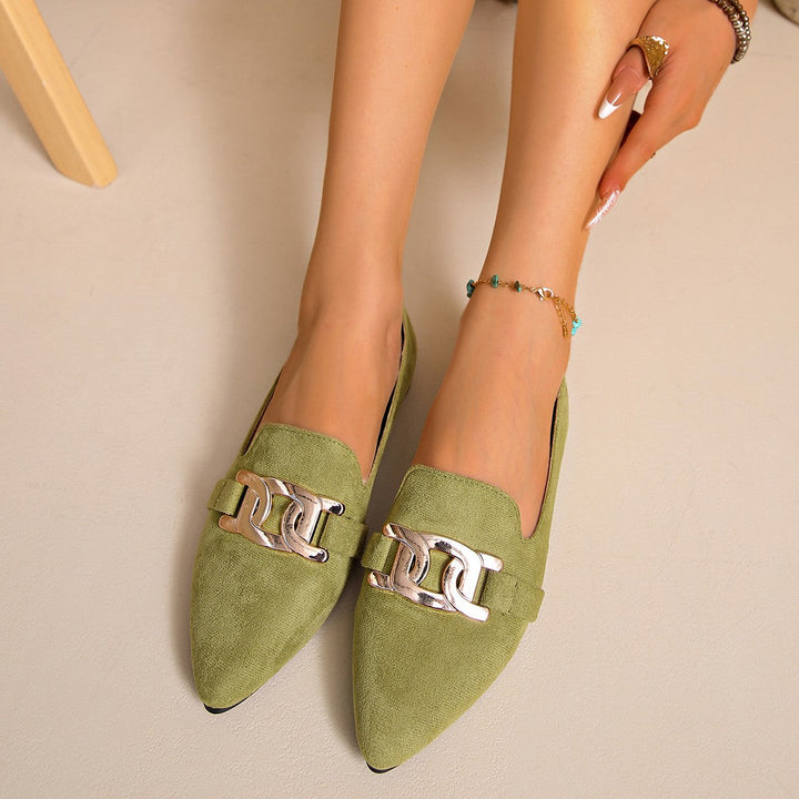 Olive green pointed toe flats worn together, front view