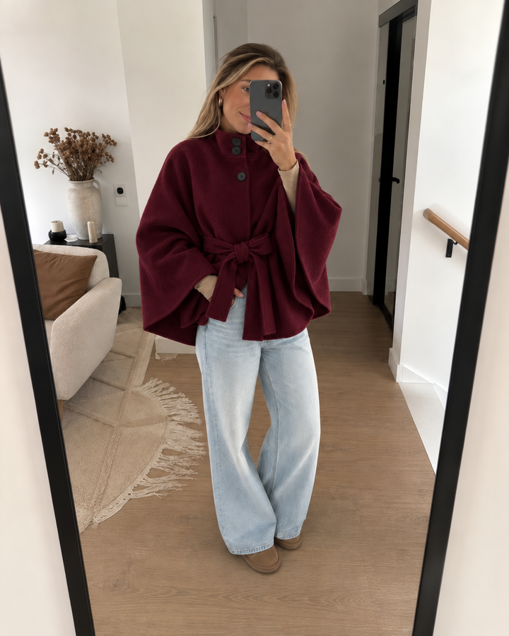 Burgundy belted cape coat in a mirror selfie with light wide leg jeans