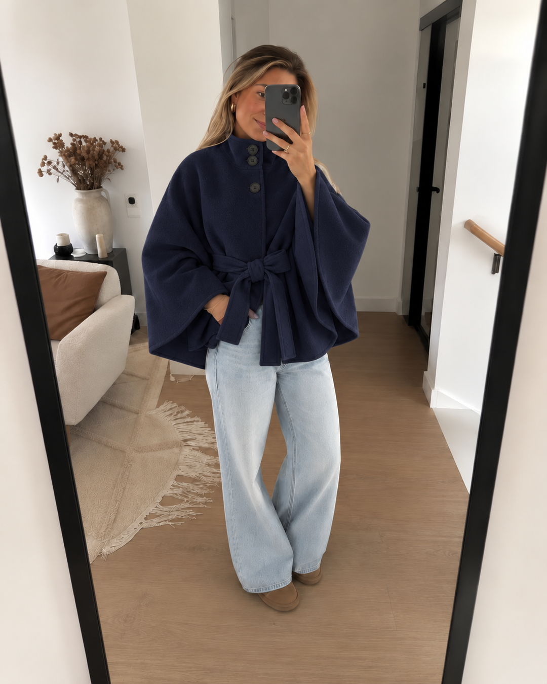 Navy belted cape coat in a mirror selfie with wide leg jeans