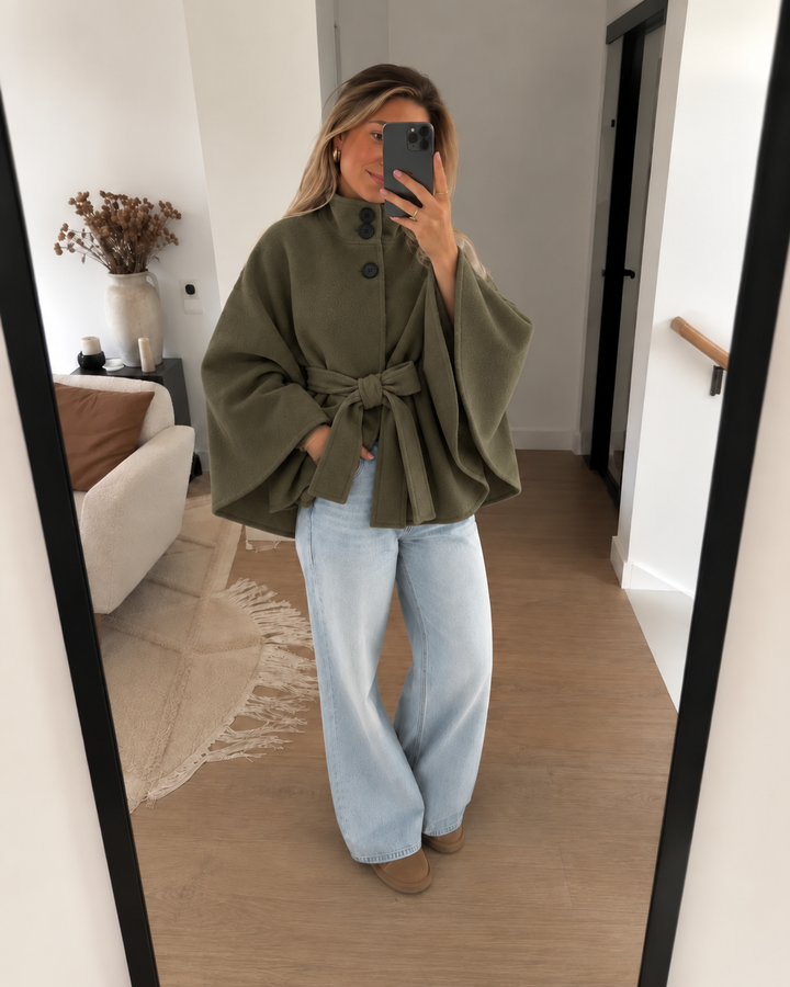 Olive green belted cape coat worn with wide leg jeans in a mirror selfie