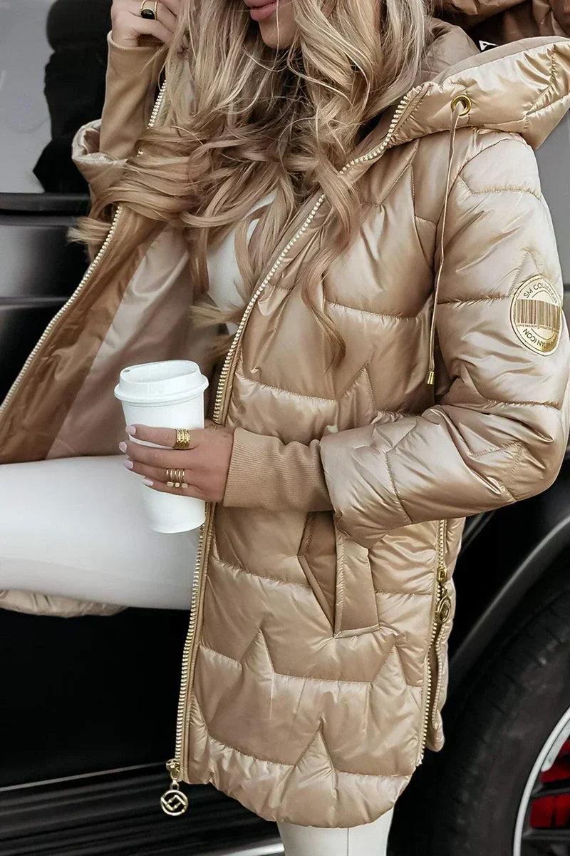Close-up of the beige quilted puffer coat sleeve badge and hood