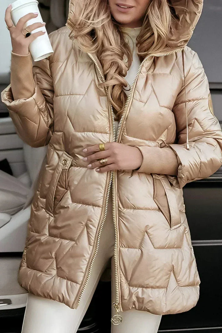 Beige quilted puffer coat open at the front, worn with white leggings
