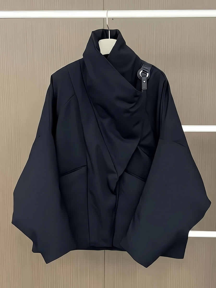 Black padded jacket on a hanger showing the folded collar and boxy shape