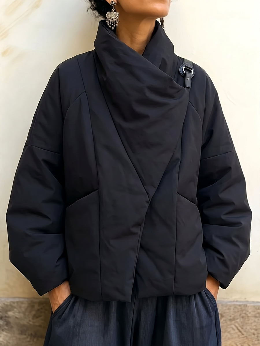 Women's puffer jacket in black with draped wrap collar and buckle tab