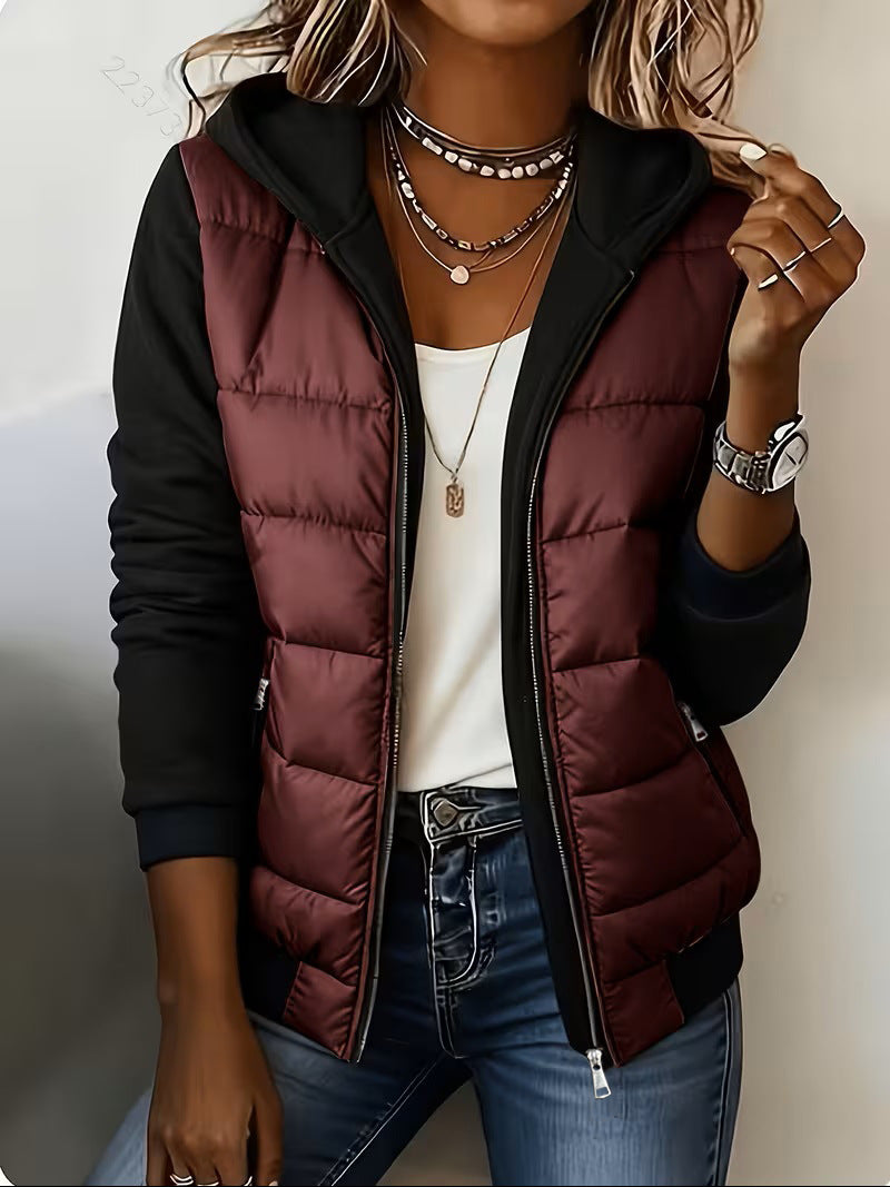 Burgundy puffer jacket with black knit sleeves and zip pockets