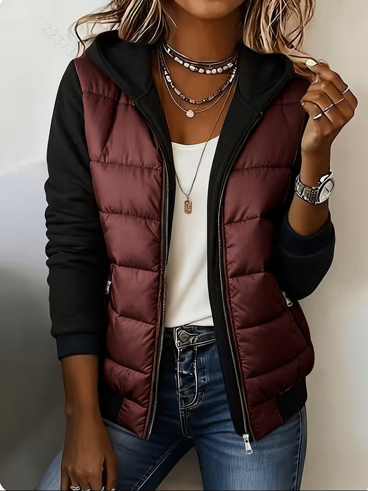 Burgundy puffer jacket with black knit sleeves and zip pockets