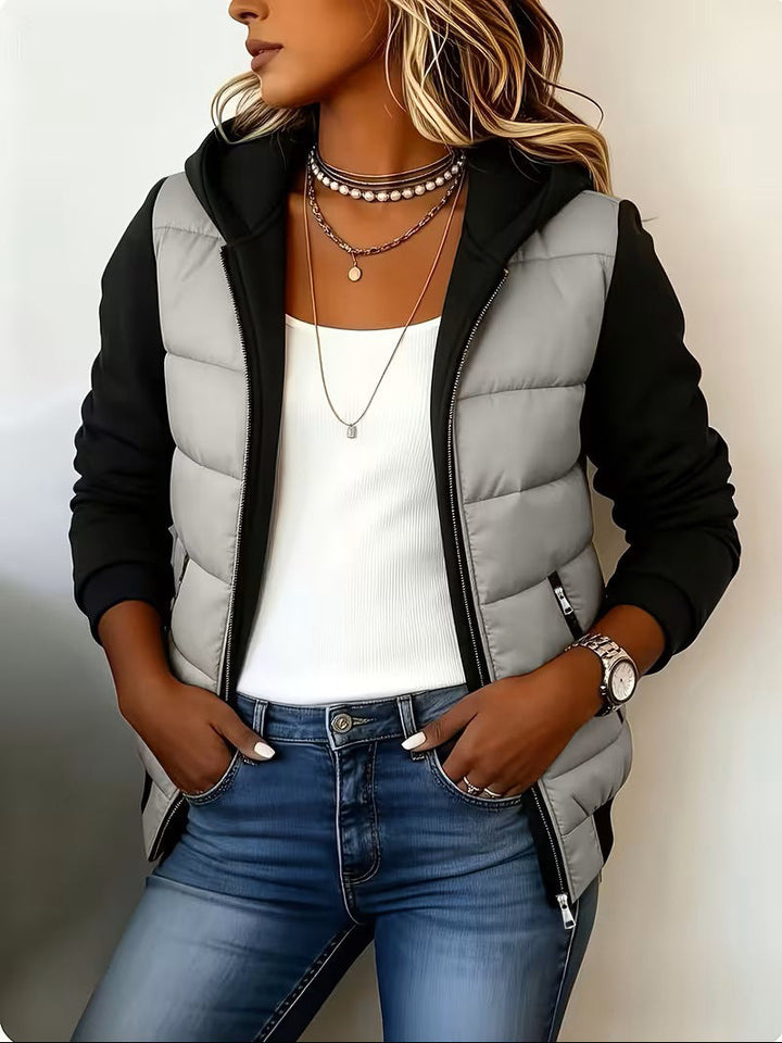 Light gray quilted jacket worn open with hands in the pockets