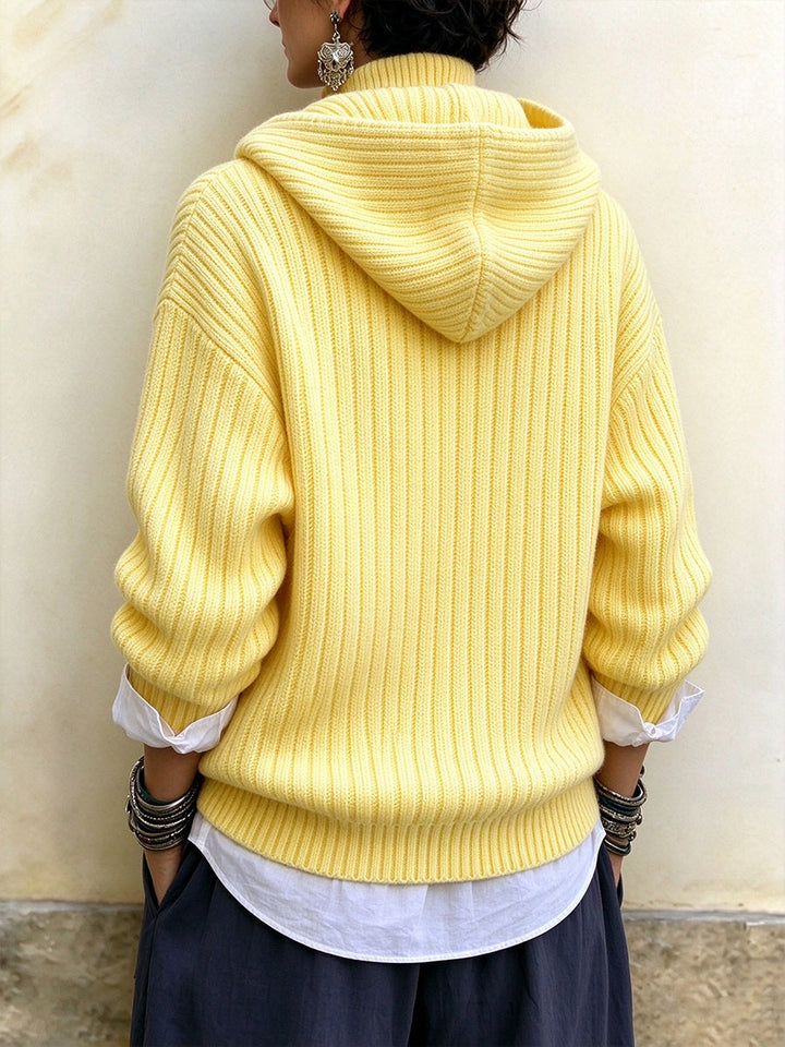 Back of the yellow sweater showing the roomy hood and ribbed texture