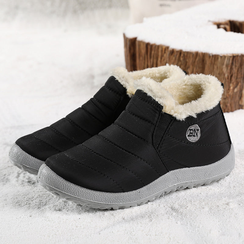Women's quilted ankle boots in black, slip on with faux fur lining, pair view