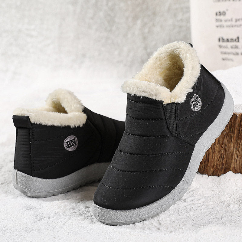 Black quilted slip on ankle boot with fleece collar, side view