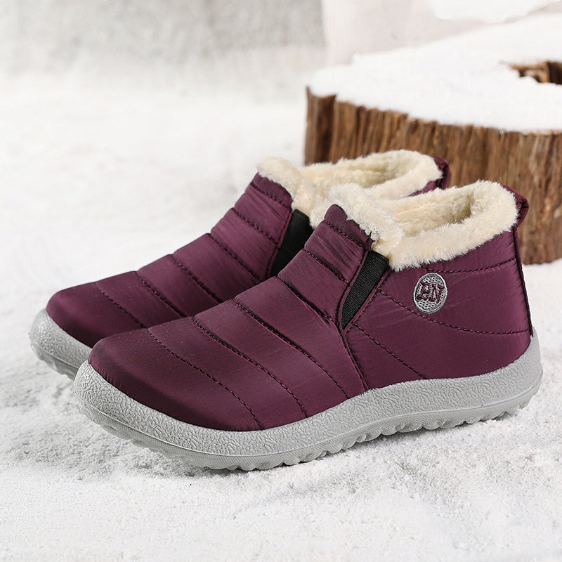 Pair of plum quilted ankle boots with elastic side and fur lining