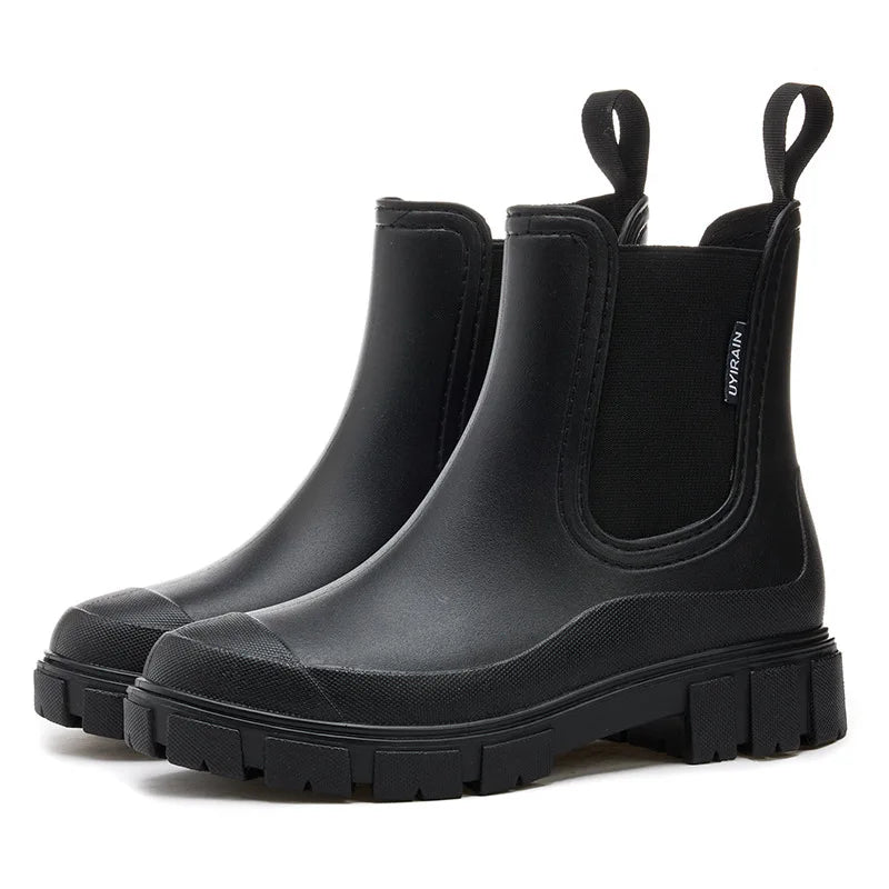 Black Chelsea rain boots with elastic side panel and lug sole, pair