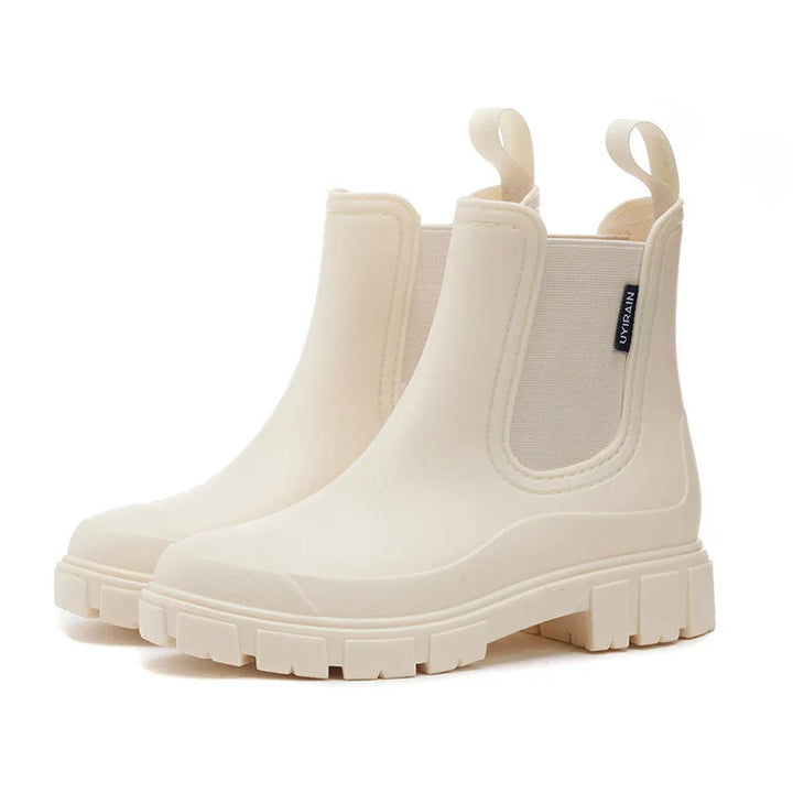 Cream Chelsea ankle rain boots with pull tabs and chunky lug sole