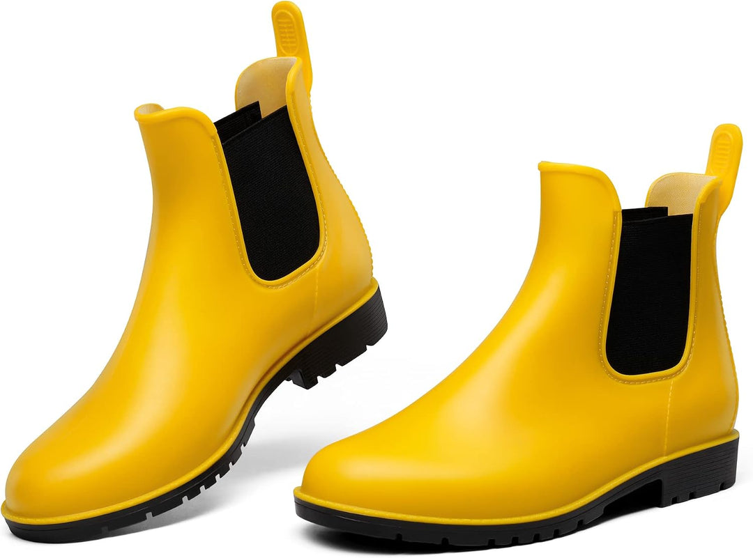 Pair of yellow Chelsea ankle rain boots with black elastic side panels