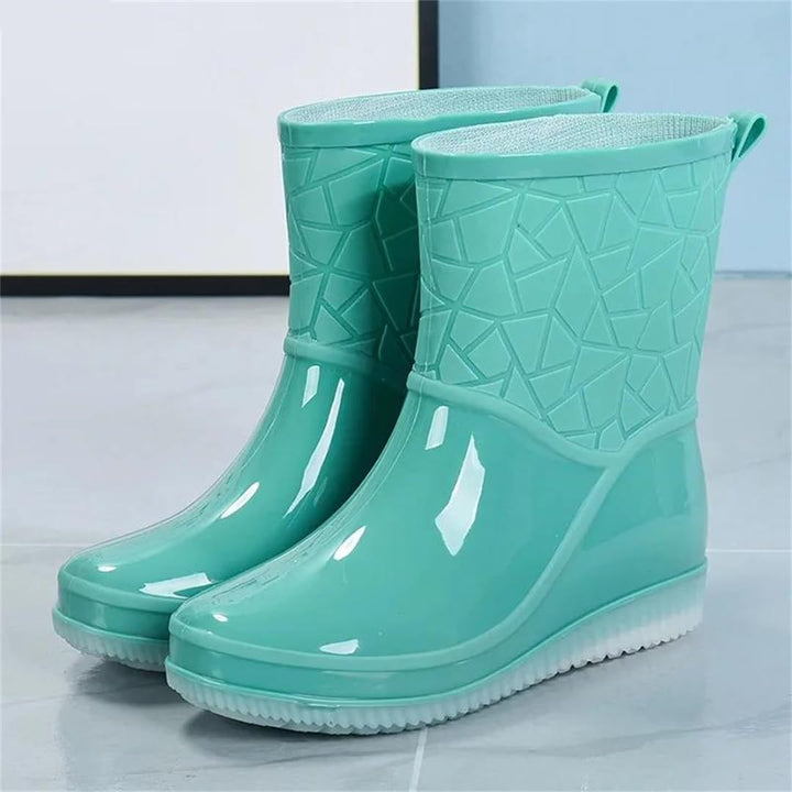 Pair of mint ankle rain boots with embossed pattern on the shaft