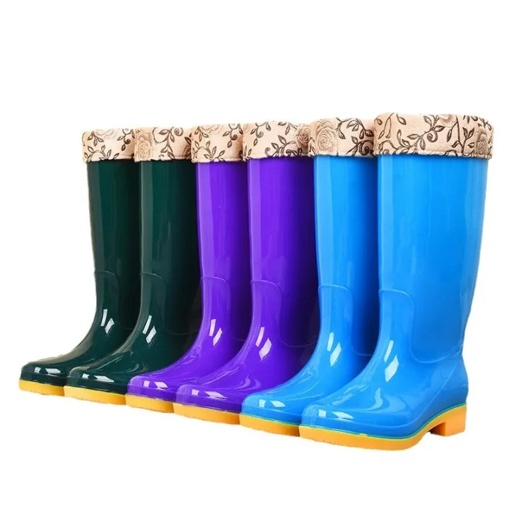 Three pairs of tall rain boots with printed cuff liners in green, purple and blue