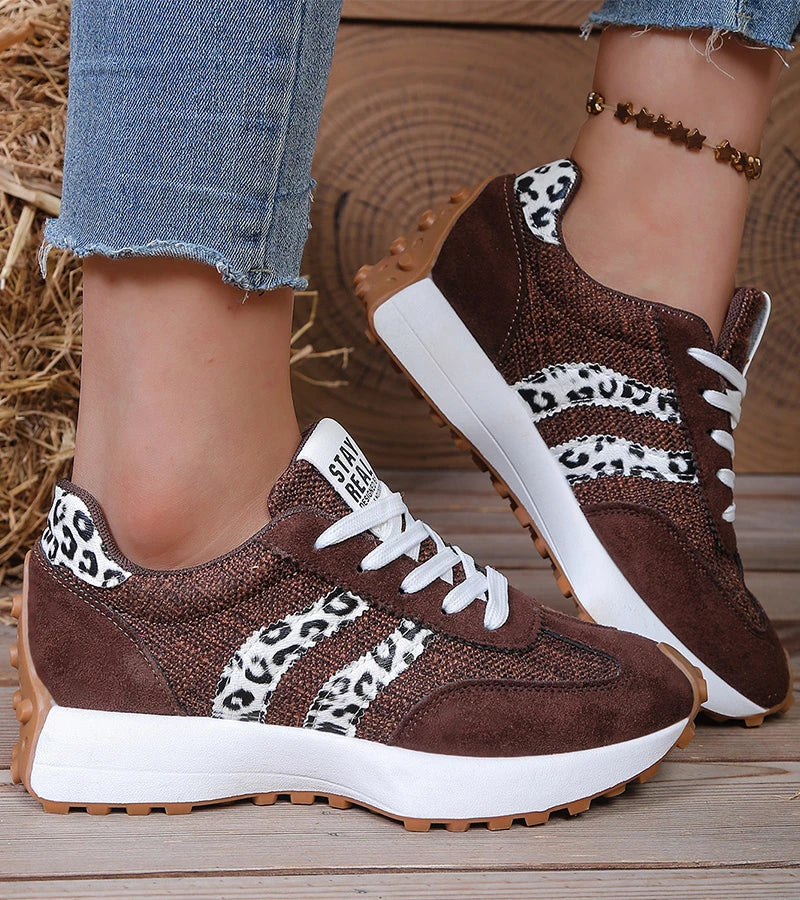 Brown suede look sneakers with leopard print stripes worn with cuffed jeans