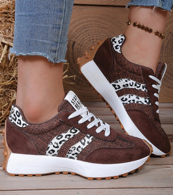Brown suede look sneakers with leopard print stripes worn with cuffed jeans