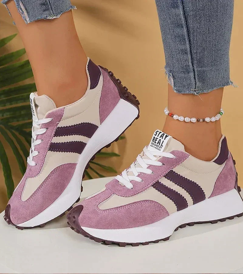 Pair of lilac retro sneakers with purple stripes and white platform soles