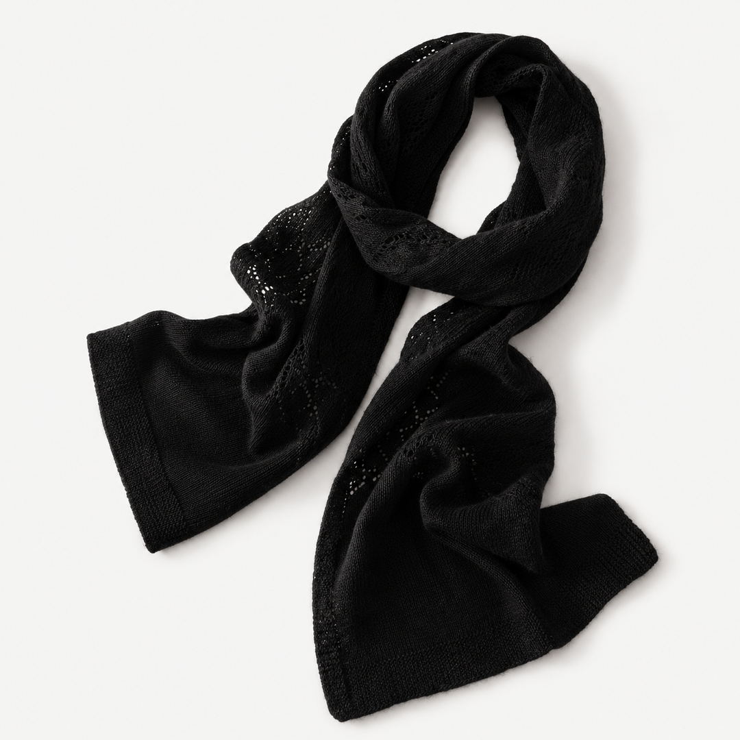 Black long knit scarf laid flat with textured pattern