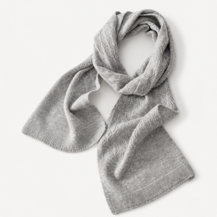Light gray long knit scarf laid flat with textured pattern