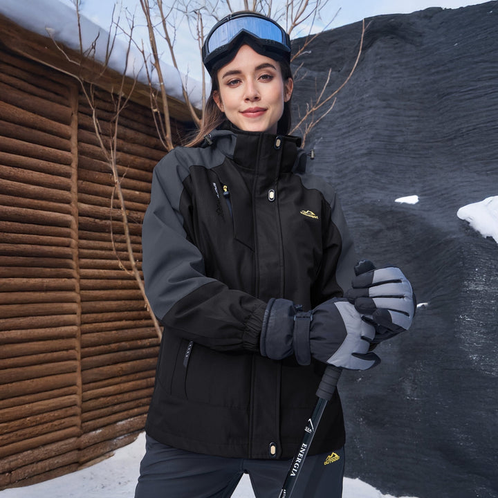 Woman wearing the black and gray snow jacket with ski gloves