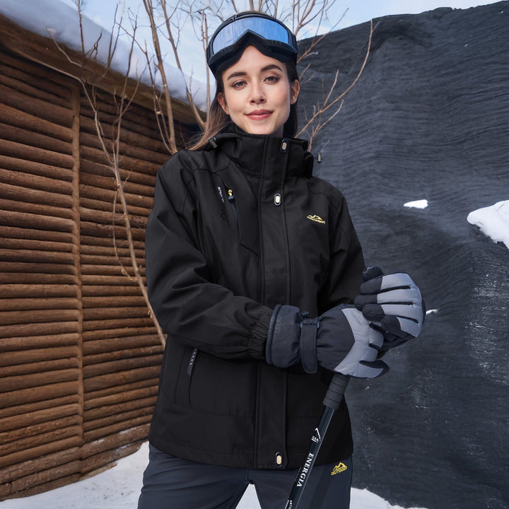 Woman wearing the black ski jacket with goggles and gloves