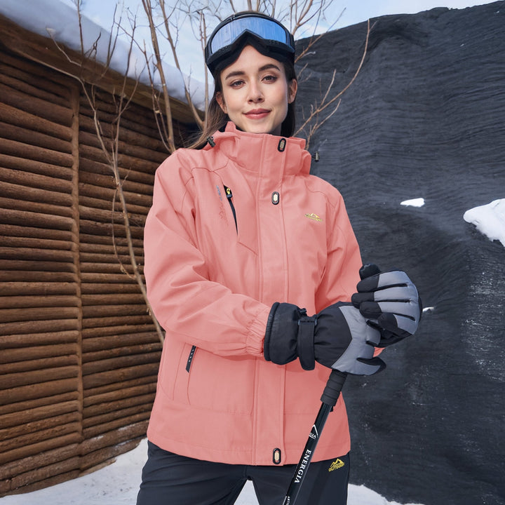 Woman wearing the peach pink snow jacket with goggles