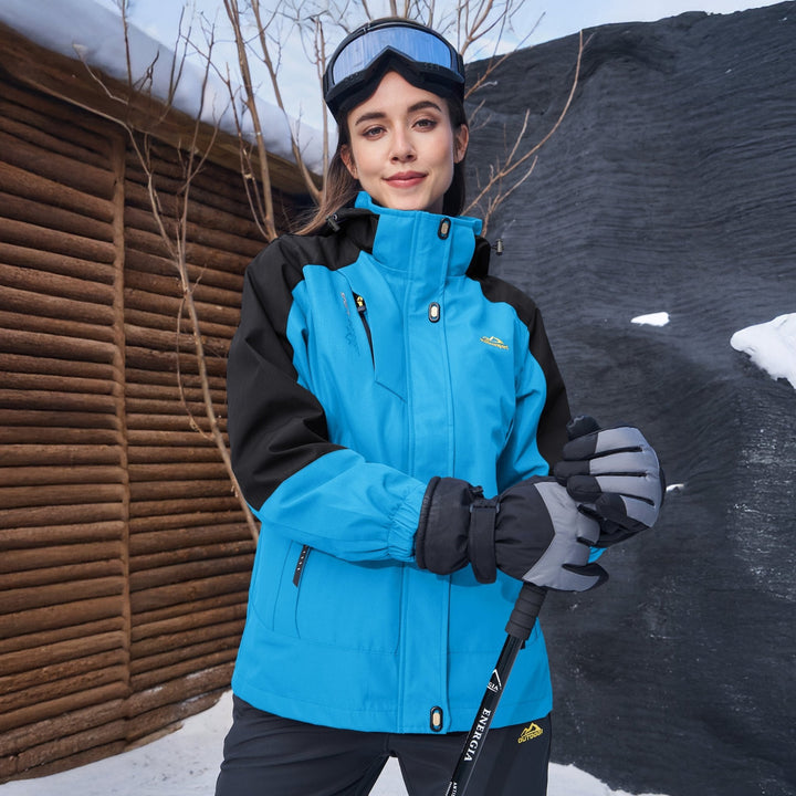 Woman wearing the sky blue snow jacket beside a log cabin