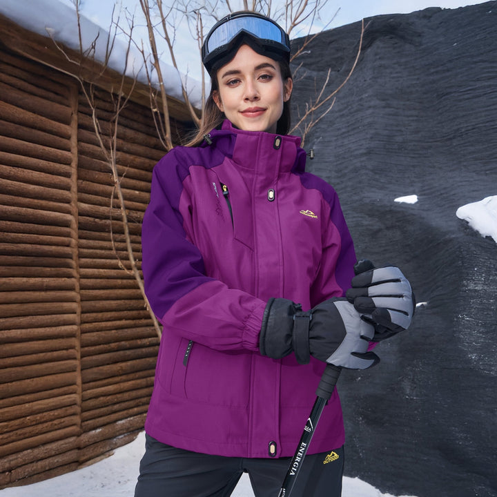 Woman in the violet winter jacket holding ski poles