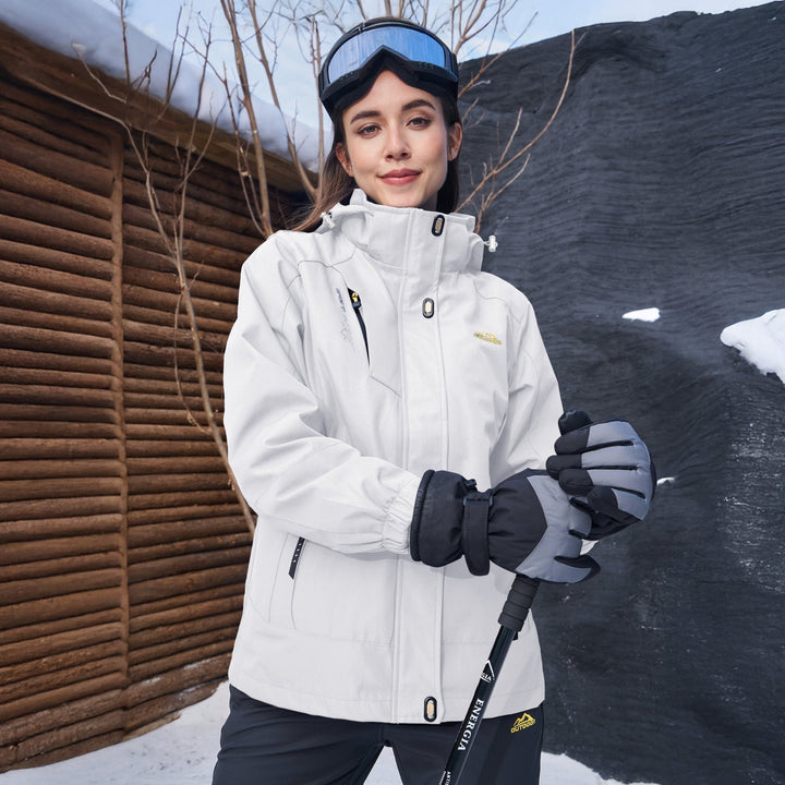 Woman wearing the white winter jacket with ski gloves