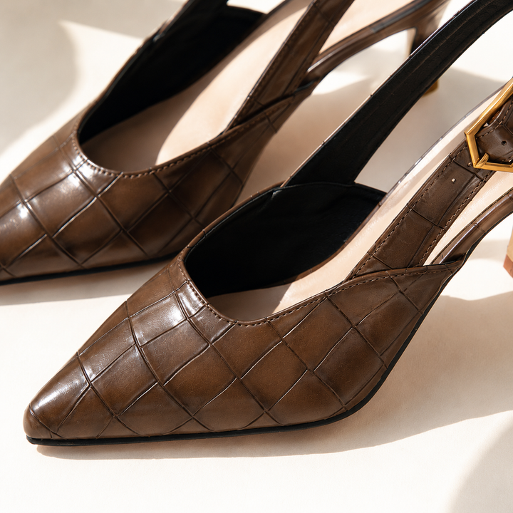 Close-up of the chocolate brown croc embossed slingback with a pointed toe