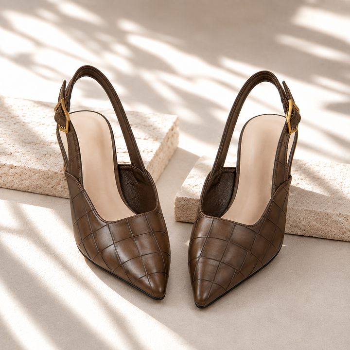 Pair of chocolate brown slingback kitten heels with pointed toe and gold buckle