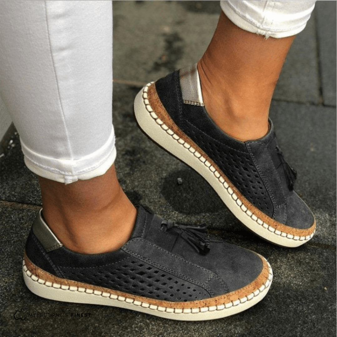 Black perforated slip on shoes with stitched sole