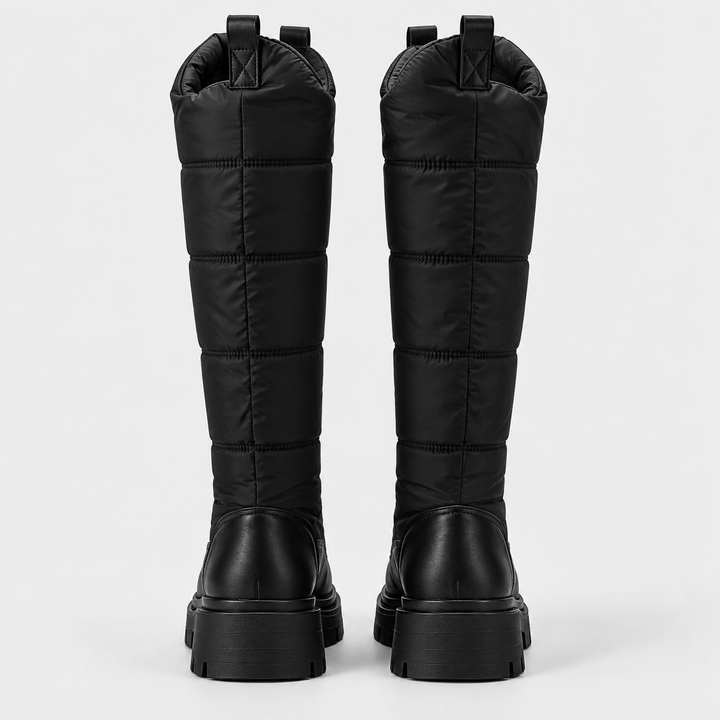 Back view of the pair of black knee high quilted snow boots