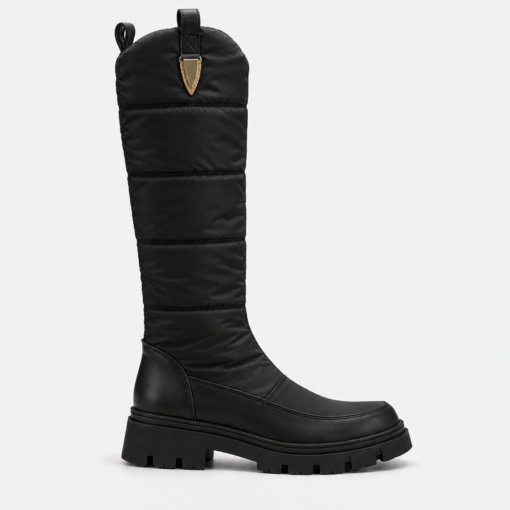 Side view of the black knee high quilted snow boot with gold tab